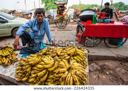 DELHI - APR 16: Market vendor selling bananas on a local market on April 16, 2011 in Delhi, India. India ranks second worldwide in farm output. Agriculture employs 52.1% of the total workforce.