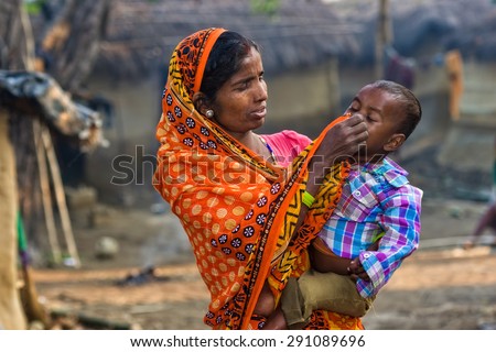RAXAUL, INDIA - NOV 8: Unidentified Indian woman with her child on Nov 8, 2013 in Raxaul, Bihar state, India. Bihar is one of the poorest states in India. The per capita income is about 300 dollars.