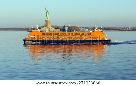 NEW YORK, USA, APRIL 19, 2015: Early morning sunlight reflecting off the Staten Island Ferry, a free ferry service between St. George on Staten Island and Whitehall Street in lower Manhattan