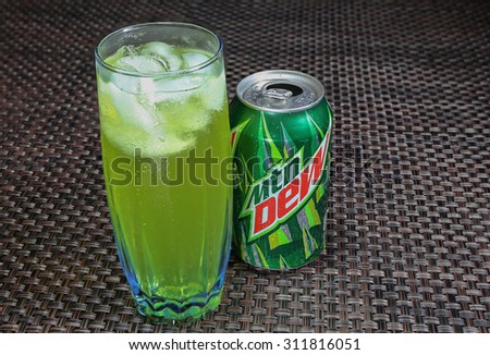 SEATTLE, USA - AUGUST 30, 2015: A glass of ice cold Mountain Dew drink with an empty can next to glass. Mountain Dew is a citrus-flavored soft drink.
