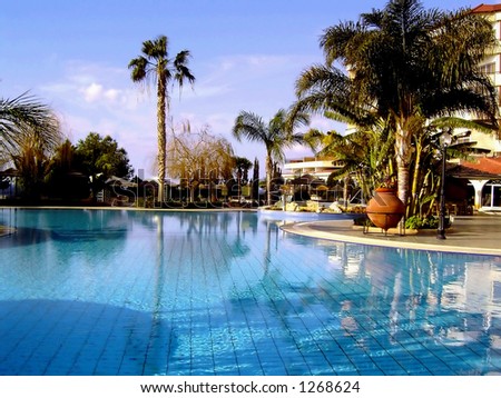View on a swimming pool in exotic location (a holiday resort).