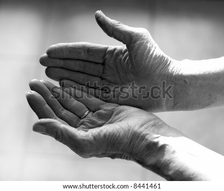 Old woman palm open up as a gesture of peace and giving thanks