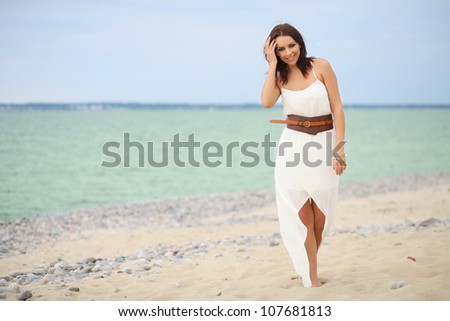 cheerful woman walks by the sea