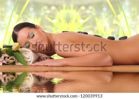 young girl on stone therapy at the spa salon