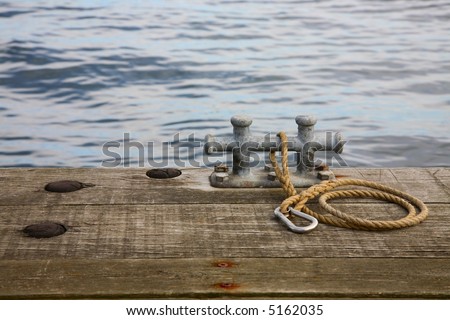 Mooring bitt with rope and snap hook