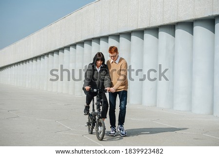 Similar – Image, Stock Photo Young man riding ebike in the park