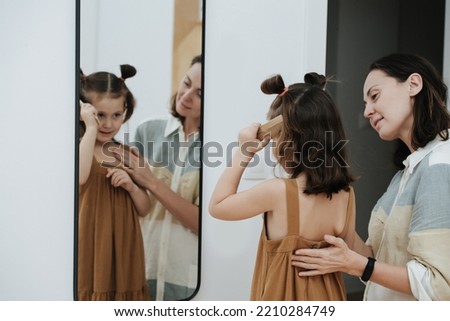 Similar – Image, Stock Photo Mirror image of two female legs and a hand with red nail polish in the mirror