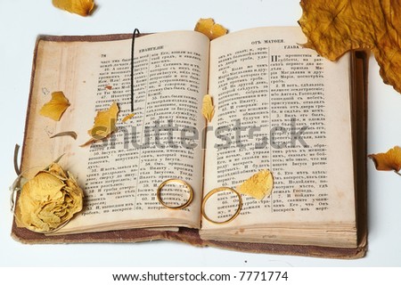 rings and faded flower on the old holy bible