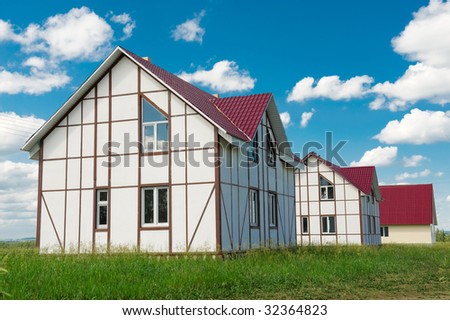 Brand new home for sale with bright sky background