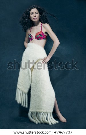 Picture of beautiful young woman.Big scarf wrapped around a beautiful woman body. Vertical view.