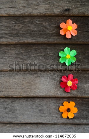 Colorful origami flower on wooden wall, thailand