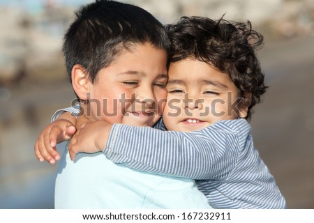 portrait of two little brothers hugging