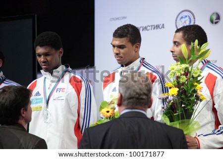 KIEV, UKRAINE - APRIL 14, 2012: French men\'s epee team on Medal ceremony during World Fencing Championship on April 14, 2012 in Kiev, Ukraine