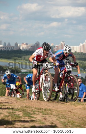 MOSCOW, RUSSIA - JUNE 9: Swiss Matthias Stirnemann (bike number 6), Czech Jan Nesvadba (number 34) and other in the European Mountain Bike Cross-Country Championship in Moscow, Russia at June 9, 2012