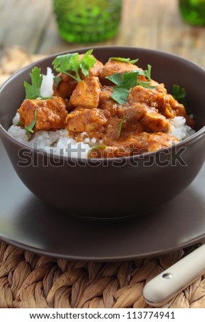 Chicken curry with rice and parsley in a bowl