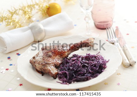 Goose leg and braised red cabbage on a Christmas table