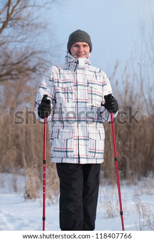 Mature man performing Nordic walking in a forest