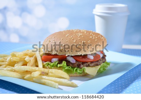Hamburger and fried potato on a paper plate