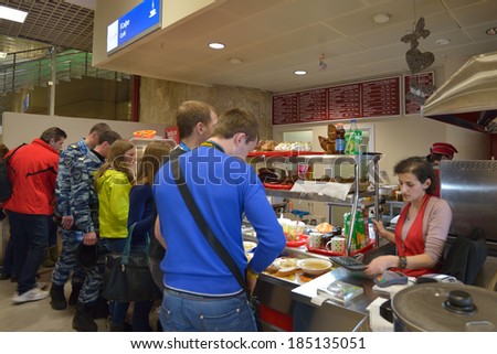 ADLER, SOCHI, RUSSIA - FEBRUARY 12, 2014: People in the cafe of Olympic Park train station. Locals prefer cafes and restaurants outside of Olympic venues due to their much cheaper prices