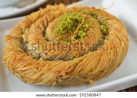 Turkish pastry kadayif with honey and pistachio nuts
