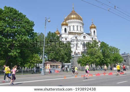 MOSCOW, RUSSIA - MAY 18, 2014: Runners on the distance of Moscow Half Marathon against the Cathedral of Christ the Saviour. It is the second race of the Moscow Marathon race series