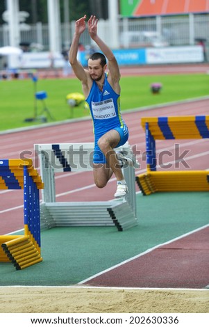 ZHUKOVSKY, MOSCOW REGION, RUSSIA - JUNE 27, 2014: Maksim Nesterenka of Belarus performs triple jump during Znamensky Memorial. The competitions is one of European Athletics Outdoor Classic Meetings