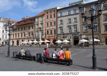 KRAKOW, POLAND - SEPTEMBER 15, 2013: People resting on the Little Market square. This square sometimes used as the spot for fairs, festivals, promotions and smaller events
