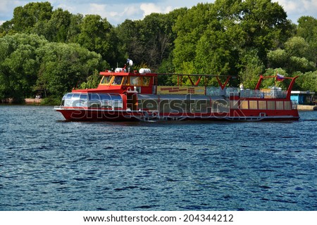MOSCOW, RUSSIA - JULY 4, 2014: Trip boat of Rechflot company on the Moscow canal. The company also offers luxury river cruises to St. Petersburg, Astrakhan, etc.