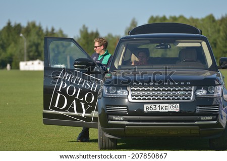 TSELEEVO, MOSCOW REGION, RUSSIA - JULY 26, 2014: British polo players in the Range Rover car during the British Polo Day. It was the second British Polo Day in Russia