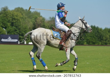 TSELEEVO, MOSCOW REGION, RUSSIA - JULY 26, 2014: Esteban Panelo of Moscow Polo club in action in the match against the team of British Schools during the British Polo Day. Moscow Polo Club won 7-6