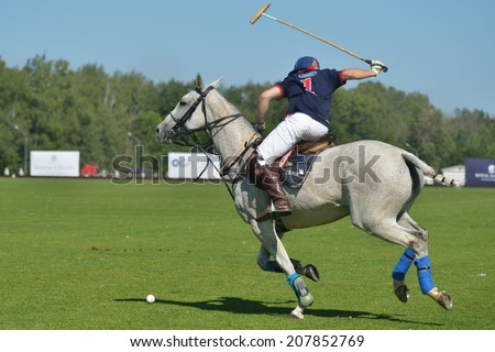 TSELEEVO, MOSCOW REGION, RUSSIA - JULY 26, 2014: Cameron Bacon of British schools in action in the match against Moscow Polo Club during the British Polo Day. Bacon become the best player of the match