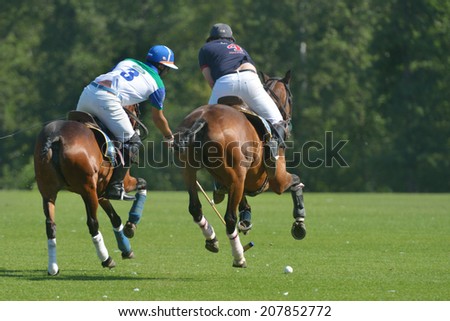 TSELEEVO, MOSCOW REGION, RUSSIA - JULY 26, 2014: Misha Rodzianko (left) of Moscow Polo Club and Ollie Browne of British Schools in action during the British Polo Day. Moscow Polo Club won 7-6