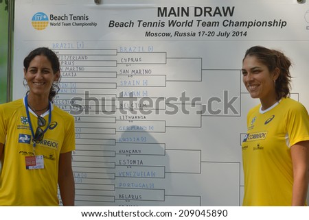 MOSCOW, RUSSIA - JULY 17, 2014: Joana Corez and Samantha Barijan of Brazil against draw board on the Beach Tennis World Team Championship. Girls share No 1 in the world rankings