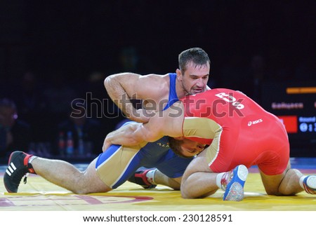 NOVOSIBIRSK, RUSSIA - NOVEMBER 8, 2014: Greco-Roman wrestling match Aslan Abdullin (blue singlet) vs Valery Gusarov during the Friendship Cup. The competitions include 10 kind of martial arts