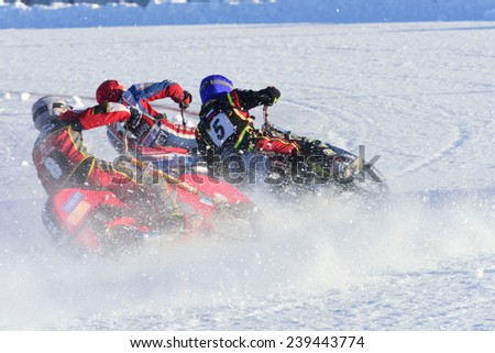 NOVOSIBIRSK, RUSSIA - DECEMBER 20, 2014: Unidentified bikers during the semi-final individual rides of Russian Ice Speedway Championship. The sports returns to the sport arenas after a decline
