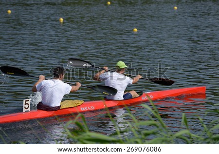 DNEPROPETROVSK, UKRAINE - MAY 29, 2013: Unidentified paddlers in the kayak racing during Ukrainian paddling championships. Dnepropetrovsk rowing canal is the main Ukrainian sport arena in kayaking
