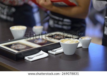 DNEPROPETROVSK, UKRAINE - MAY 30, 2013: Cups of coffee made on 5th Ukrainian Latte Art Championship in Dnepropetrovsk, Ukraine on May 30, 2013