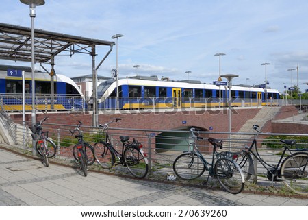 KEMPEN, GERMANY - JUNE 29, 2013: Bicycles against a modern commuter train. Germany implements the National Cycling Plan to increase the bicycle share of urban trips
