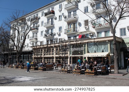 ODESSA, UKRAINE - MARCH 23, 2015: People resting in the restaurant Compote on Deribasovskaya street. The street is the main tourist attraction of the city with dozens of cafes, restaurants, and shops