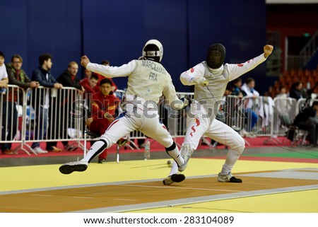 ST. PETERSBURG, RUSSIA - MAY 2, 2015: Marcel Marcilloux of France (left) vs Jianfei Ma of China in 1/32 final of 41th International fencing tournament St. Petersburg Foil, the stage of FIE World Cup