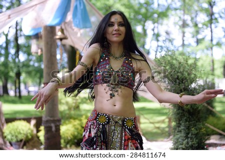 ST. PETERSBURG, RUSSIA - JUNE 4, 2015: Woman performing belly dance during the festival Emperor's Gardens of Russia. The exposition Silk Road Gardens is in focus of festival this year