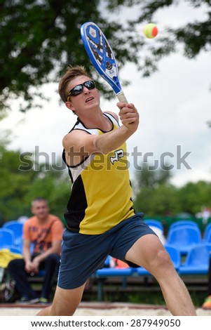 MOSCOW, RUSSIA - MAY 31, 2015: Nikolay Guriev in the match of Russian beach tennis championship. 120 adults and 28 young athletes compete in the tournament