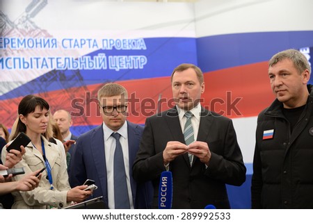ST. PETERSBURG, RUSSIA - JUNE 20, 2015: General director of JSC Rosseti Oleg Budargin (center) talk with press during the presentation of the project of Federal Test Center for electrical equipment