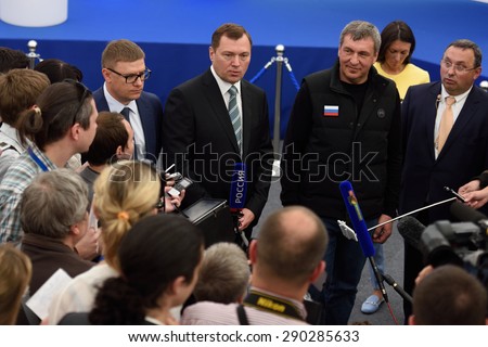 ST. PETERSBURG, RUSSIA - JUNE 20, 2015: General director of JSC Russian Grids Oleg Budargin (center) talk with press during the presentation of the project of the Federal Test Center