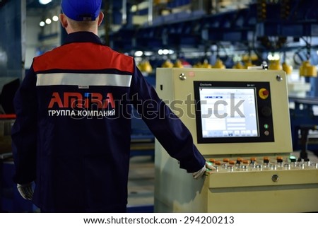 ST. PETERSBURG, RUSSIA - JUNE 30, 2015: Worker at work in the Megapolis plant owned by Amira Group. It\'s Russia\'s largest plant producing the lighting poles