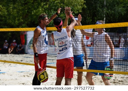MOSCOW, RUSSIA - JULY 15, 2015: Men doubles of France and Israel greeting one another after the match during the ITF Beach Tennis World Team Championship. 28 nations compete in the event this year