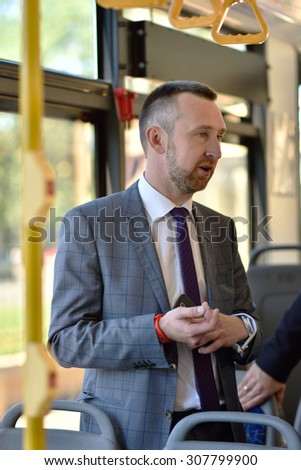 ST. PETERSBURG, RUSSIA - AUGUST 17, 2015: Vice president and senior business development manager of Mastercard Anton Shigapov demonstrate the PayPass technology in urban transport ticketing system