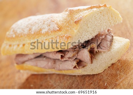 Roast beef sandwich on the wooden cutting board