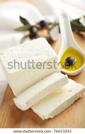 Feta cheese with black olives in olive oil