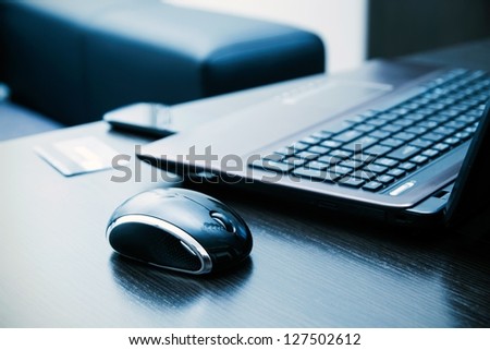 Laptop, mouse, credit card on desk